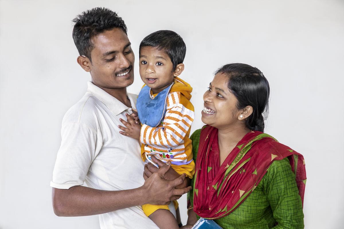 mother and father holding their young child
